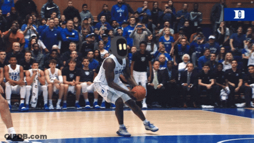A Duke Basketball Player Is Dribbling A Basketball On The Court GIF