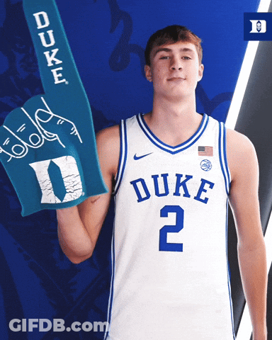 A Duke Basketball Player Is Holding A Blue Duke Foam Hand GIF