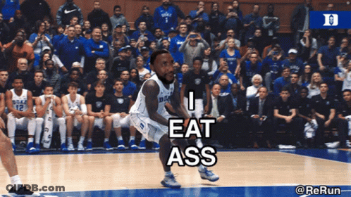A Duke Basketball Player Is Jumping In The Air While A Crowd Watches GIF