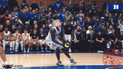 A Duke Basketball Player Wearing A Mask Throws The Ball GIF