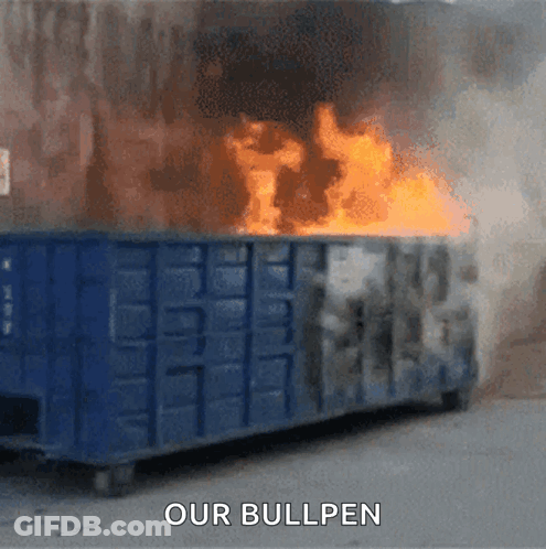 A Dumpster Is On Fire With The Words " Our Bullpen " Above It GIF