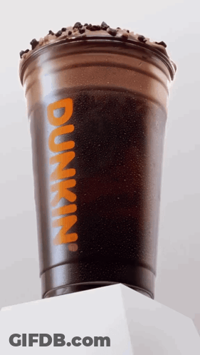 A Dunkin ' Cup With Iced Coffee And Chocolate Chips On Top GIF