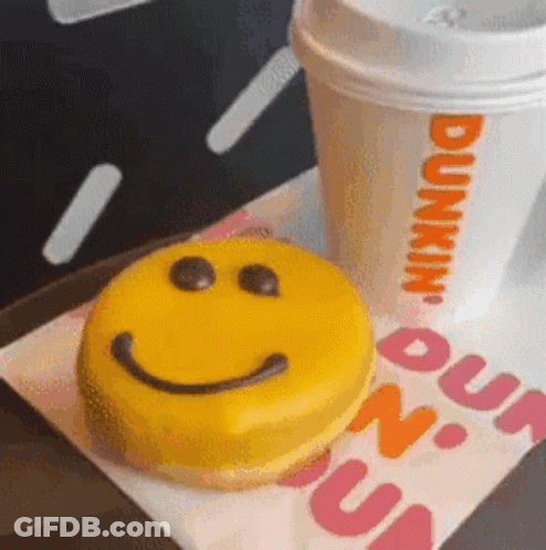 A Dunkin Donut With A Smiley Face On It GIF