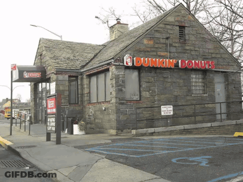 A Dunkin ' Donuts Building With A Handicapped Parking Spot GIF