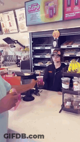 A Dunkin ' Donuts Worker Serves A Customer GIF