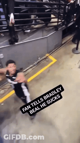 A Fan Tells Bradley Beal He Sucks While A Man Stands In The Background GIF
