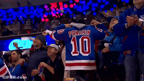A Fan Wearing A Panarin 10 Jersey Is Surrounded By Other Fans GIF
