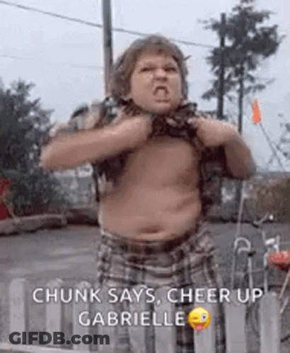 A Fat Boy Is Standing In Front Of A Fence With His Shirt Off And Making A Funny Face . GIF