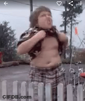 A Fat Boy Is Standing In Front Of A White Fence . GIF