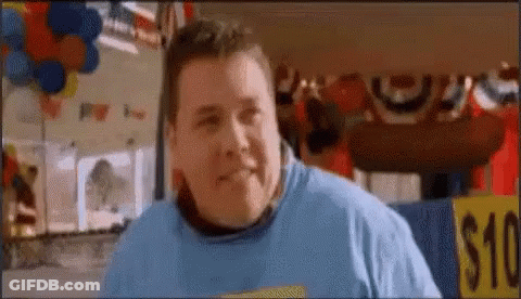 A Fat Man In A Blue Shirt Is Standing In Front Of A $ 10 Sign . GIF