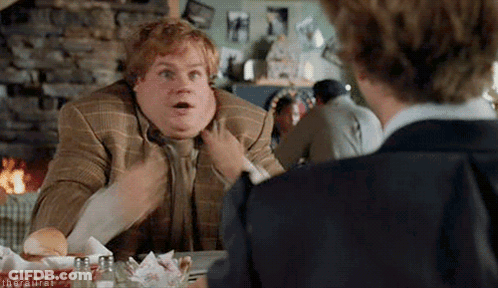 A Fat Man In A Suit And Tie Is Sitting At A Table Talking To Another Man In A Restaurant . GIF