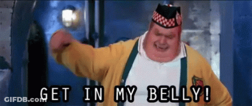 A Fat Man In A Yellow Sweater And Suspenders Says Get In My Belly GIF