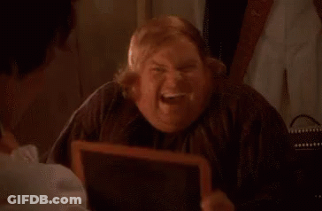A Fat Man Is Looking At Himself In A Mirror And Smiling . GIF