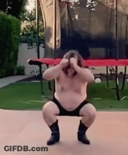 A Fat Man Is Squatting Down In Front Of A Trampoline . GIF