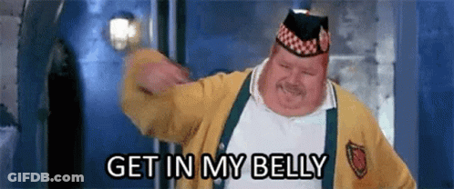 A Fat Man Wearing A Yellow Sweater And A Hat Is Dancing And Says `` Get In My Belly '' . GIF