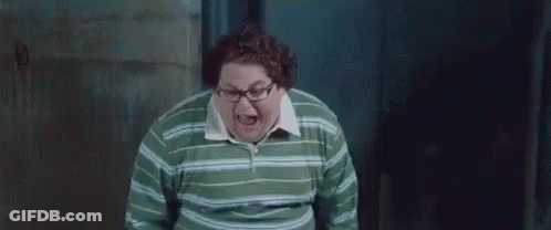 A Fat Man Wearing Glasses And A Green Striped Shirt Is Screaming . GIF