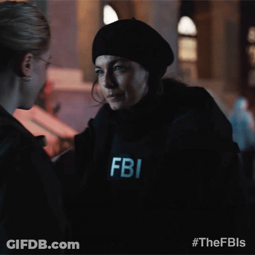 A Fbi Officer Is Talking To Another Woman GIF