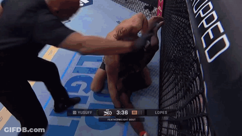 A Featherweight Bout Between Yusuff And Lopes Is Being Shown On A Screen GIF