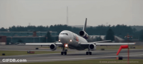 A Fedex Airplane Is Taking Off From An Airport GIF