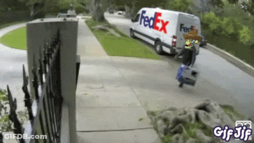 A Fedex Van Is Driving Down The Street GIF