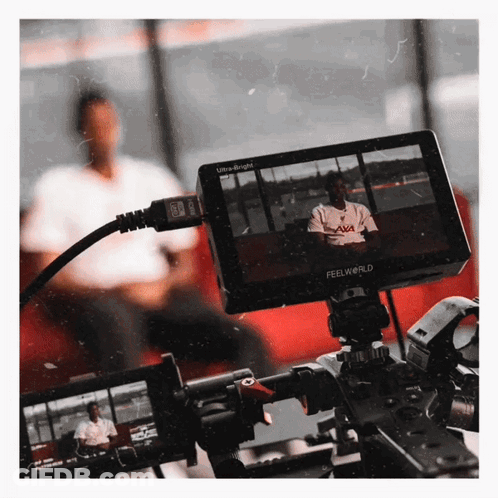 A Feelworld Monitor Shows A Man Sitting In Front Of A Window GIF