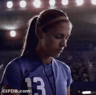 A Female Athlete Wearing A Blue Jersey With The Number 13 On It GIF