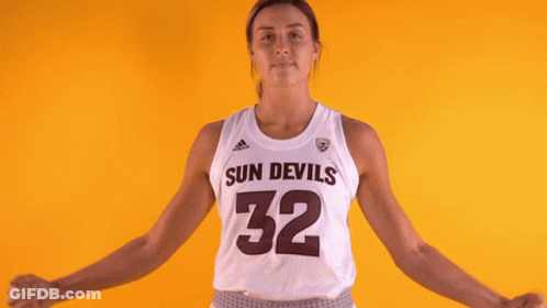A Female Basketball Player For The Sun Devils Is Flexing Her Muscles GIF