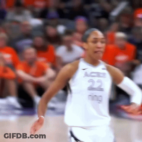 A Female Basketball Player Is Standing On The Court During A Game . GIF