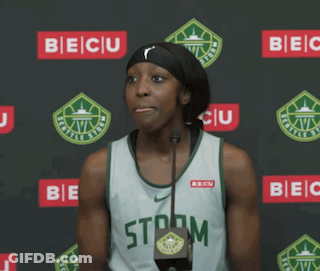 A Female Basketball Player Stands In Front Of A Microphone Wearing A Storm Jersey GIF