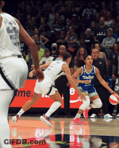 A Female Basketball Player Wearing A Dallas Jersey Is Dribbling The Ball GIF