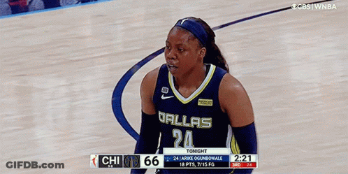 A Female Basketball Player Wearing A Dallas Jersey Stands On The Court GIF
