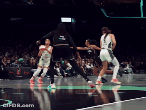 A Female Basketball Player Wearing A Jersey That Says At & T On It GIF