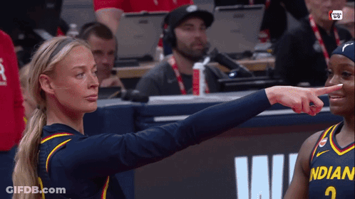 A Female Basketball Player Wearing A Jersey That Says Indian Pointing At Another Player GIF