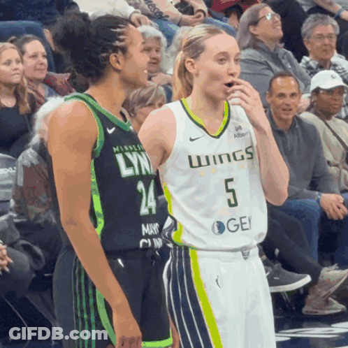 A Female Basketball Player Wearing A Jersey That Says Wings GIF