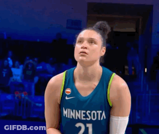 A Female Basketball Player Wearing A Minnesota Jersey Is Standing On A Court GIF