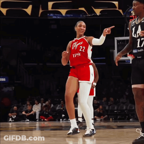 A Female Basketball Player Wearing A Red And White Uniform With The Number 22 On It GIF