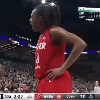 A Female Basketball Player Wearing A Red Jersey That Says Denver On It GIF