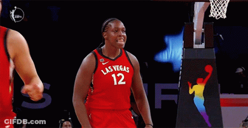 A Female Basketball Player Wearing A Red Jersey With Las Vegas 12 On It GIF