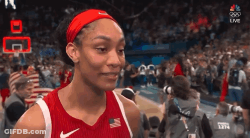 A Female Basketball Player Wearing A Red Nike Jersey And Headband GIF
