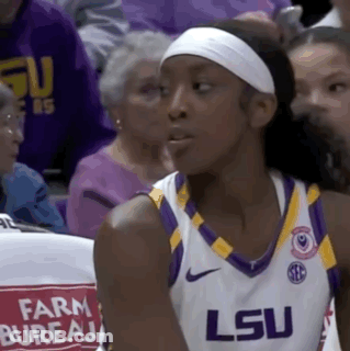 A Female Basketball Player Wearing A White Headband And A Lsu Jersey . GIF