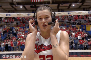 A Female Basketball Player Wearing Headphones And A Jersey With The Number 22 On It GIF