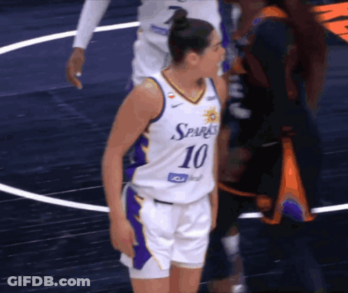 A Female Basketball Player With The Number 10 On Her Jersey Stands On The Court GIF