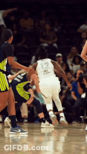 A Female Basketball Player With The Number 12 On Her Jersey GIF