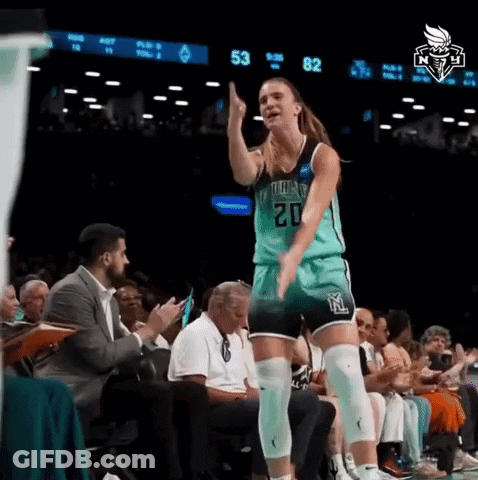 A Female Basketball Player With The Number 20 On Her Jersey Stands On The Court GIF