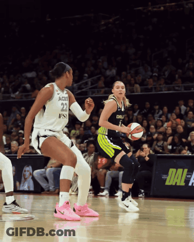 A Female Basketball Player With The Number 22 On Her Jersey Dribbles The Ball GIF