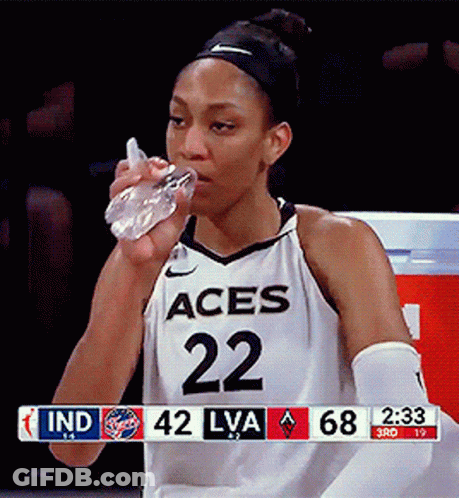 A Female Basketball Player With The Number 22 On Her Jersey Is Drinking Water GIF