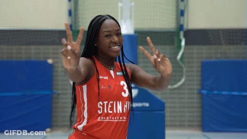 A Female Basketball Player With The Number 3 On Her Jersey Giving A Peace Sign GIF