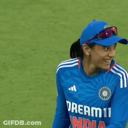 A Female Cricket Player Wearing A Blue Hat And Sunglasses Is Smiling . GIF