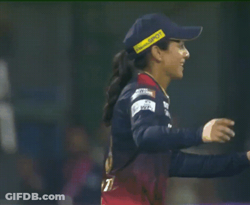 A Female Cricket Player Wearing A Blue Hat With A Yellow Stripe That Says ' Sdn ' On It GIF
