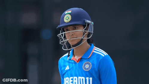 A Female Cricket Player Wearing A Helmet And A Jersey That Says Beam11 GIF